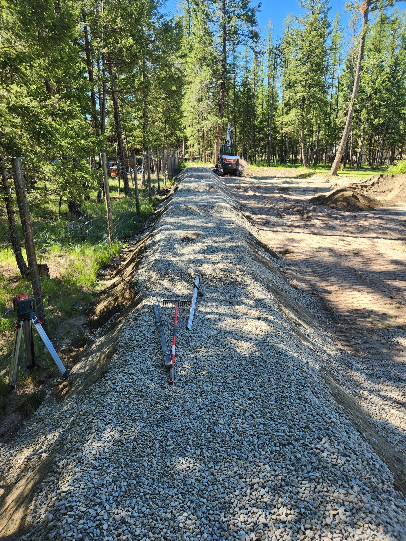 Laser level beside a precisely graded gravel distribution bed